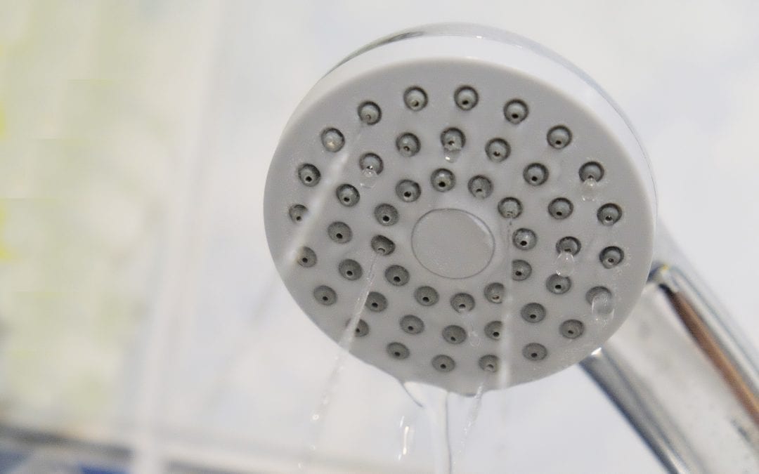 Clogged Shower Head streaming water 
