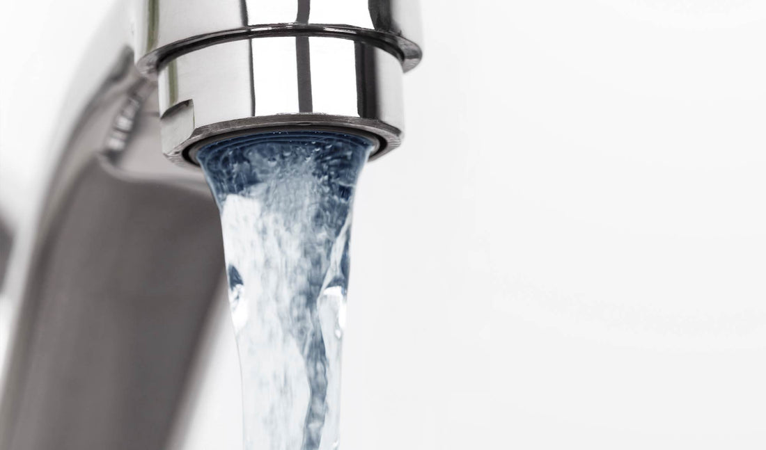 Close up shot of water faucet with running water 