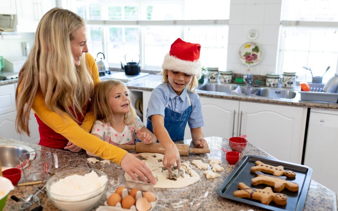 mother and children making gingerbread men 