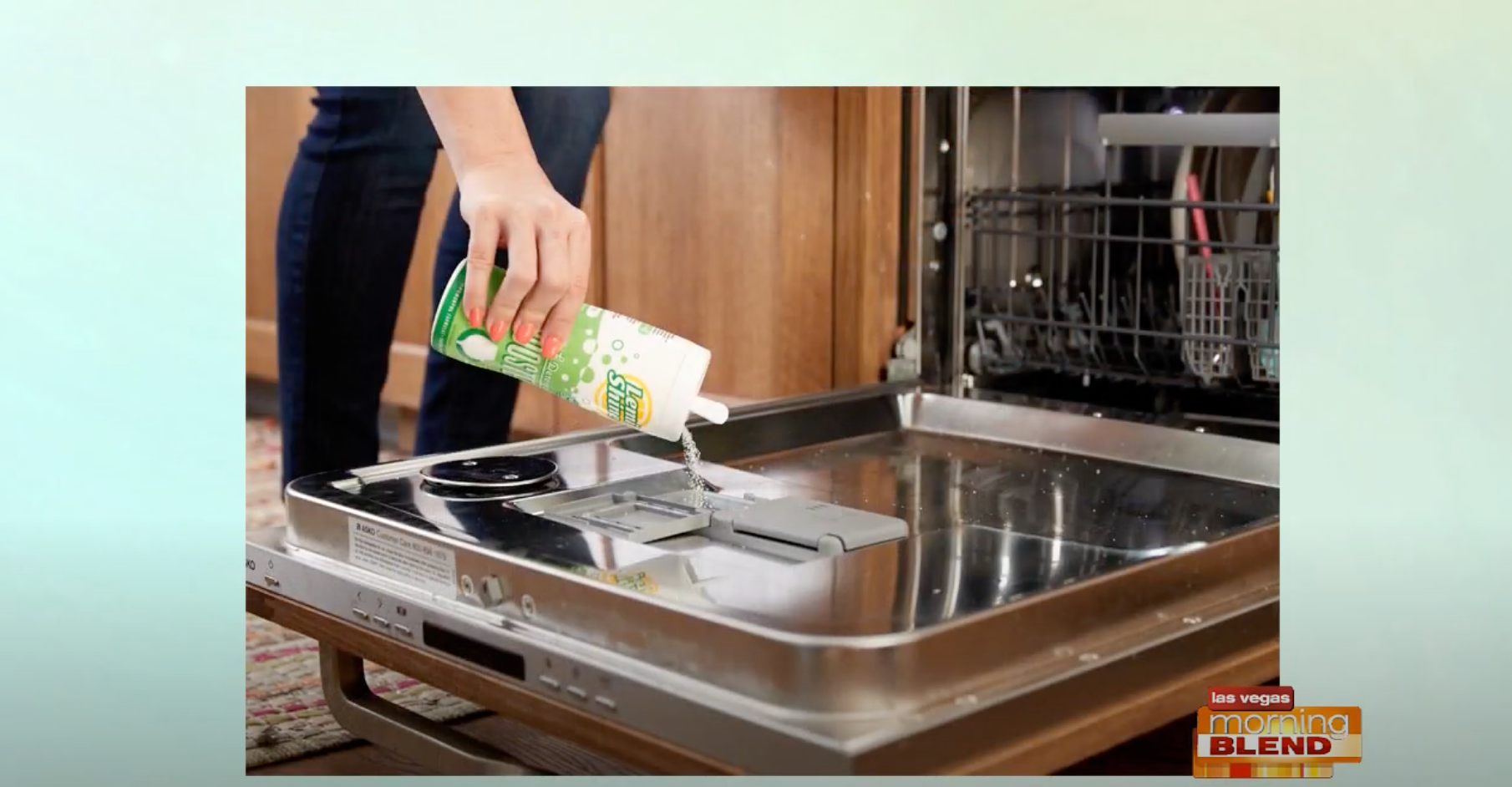 Woman pouring Booster into dishwasher 