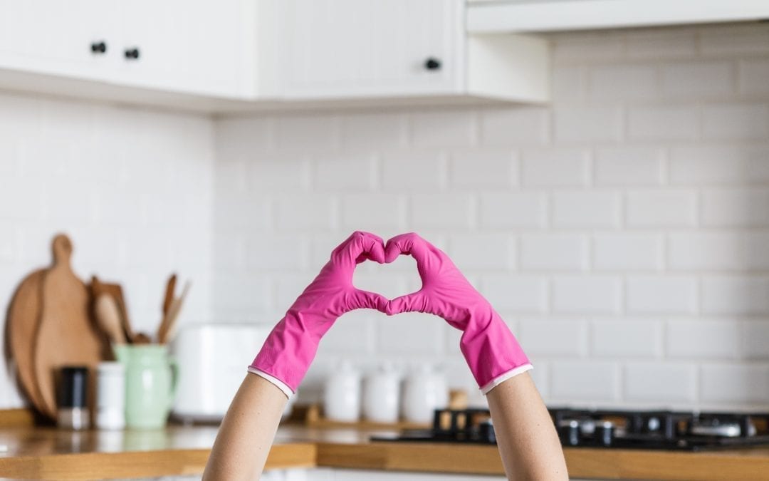 hands wearing gloves making heart gesture with fingers