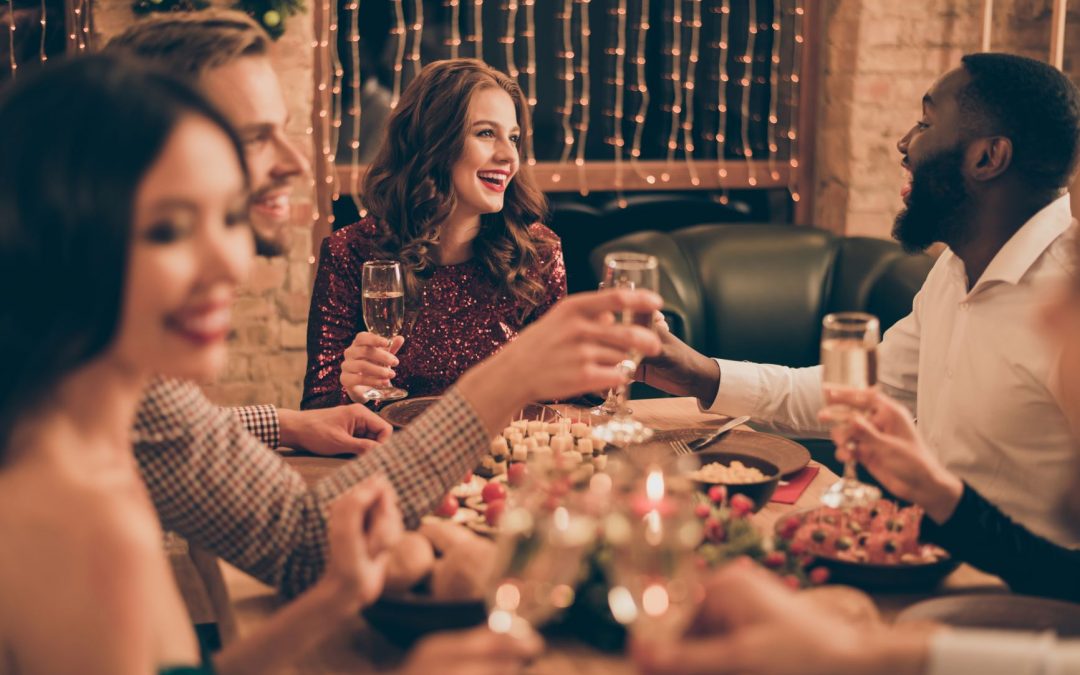 group of friends smiling at dinner table 