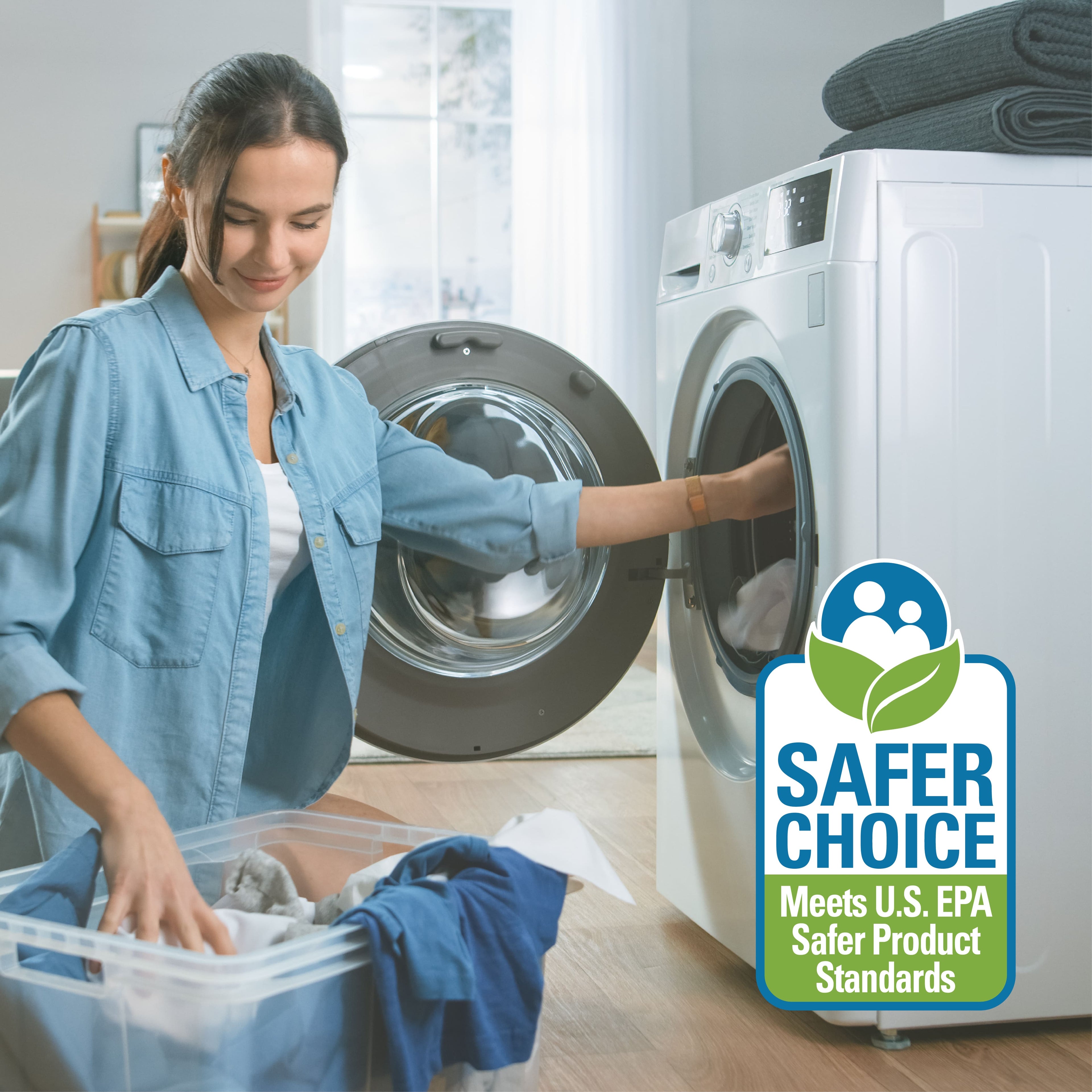 Woman loading laundry into a washing machine with a 'Safer Choice' label in the corner.