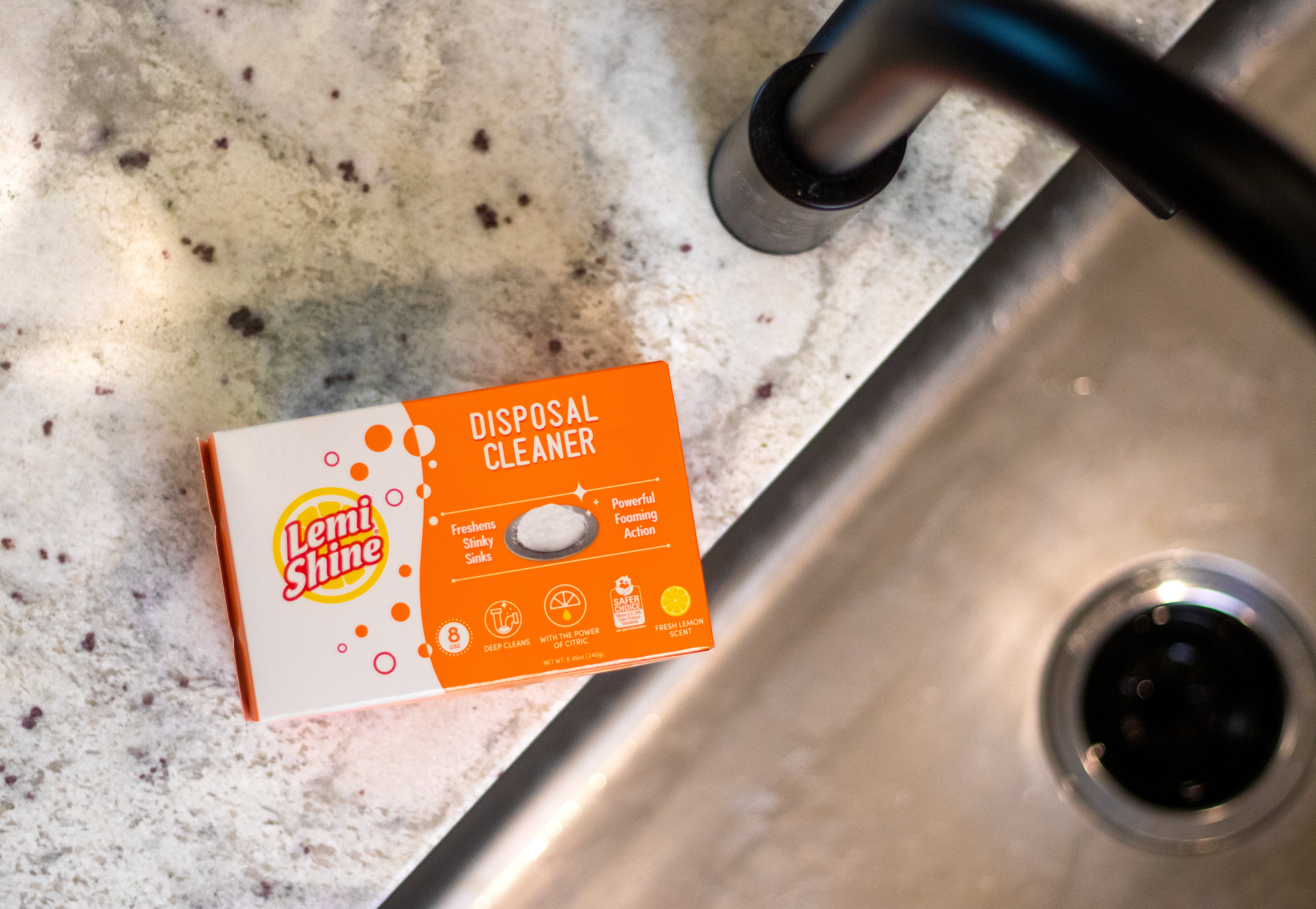 Lemi Shine disposal cleaner box on a kitchen sink with visible grime.